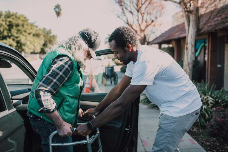 Man Helping Old Man